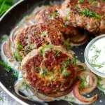 Hamburger Steaks in Creamy Dill Sauce Easy to make and ready in 30 minutes. Juicy ground beef patties seared until golden brown and simmered in a divine dill cream sauce. Serve with mashed potatoes for a perfect quick-yet-satisfying dinner. It's comfort food at its best! Prep 10minutes mins Cook 20minutes mins Total 30minutes mins Servings 4 Calories 697 Print Recipe Pin Recipe Save Recipe Ingredients US Customary Metric 1x 2x 3x Hamburger Steaks ▢1.3 pounds ground beef ▢4 tbsp breadcrumbs ▢1 yellow onion - grated ▢1 tsp salt ▢1 tsp black pepper ▢2 tbsp heavy cream ▢1 egg Creamy Dill Sauce ▢1 tbsp olive oil ▢1 tbsp unsalted butter ▢1 yellow onion - diced ▢2 garlic cloves - minced ▢1 tsp salt ▢1 tsp black pepper ▢2 tbsp all-purpose flour ▢½ cup low sodium chicken broth ▢1 cup heavy cream ▢2 tbsp chopped dill - more for serving Cook Mode Prevent your screen from going dark Instructions Start with making the hamburger steaks. Into a large bowl, grate the onion. Add ground beef, breadcrumbs, salt, pepper, cream and egg. Mix with your hands until just combined. Divide beef mixture into 4 portions, and shape each portion into a ball. Press the balls down by using the palm of your hand or a spatula until ¾ inch/2 cm thick. Set aside. Finely chop the onion, mince the garlic and chop the dill. Heat oil and butter over medium in a large nonstick skillet. Add hamburger steaks and cook 4-5 minutes per side. Transfer onto a clean plate. Add garlic and onion, reduce heat to low and cook until fragrant about 2 minutes. Add salt, pepper and flour, stir until incorporated. Pour in broth and simmer for 2 minutes while scraping up the brown bits on the bottom of your skillet with a wooden spoon. Add cream and dill, bring to a boil and simmer for 1-2 minutes until the sauce starts to thicken. Return hamburger steaks to the skillet and simmer for 5-6 minutes until heated through and no longer raw in the center. Finish off with chopped dill and freshly grated black pepper. Serve! Video Nutrition